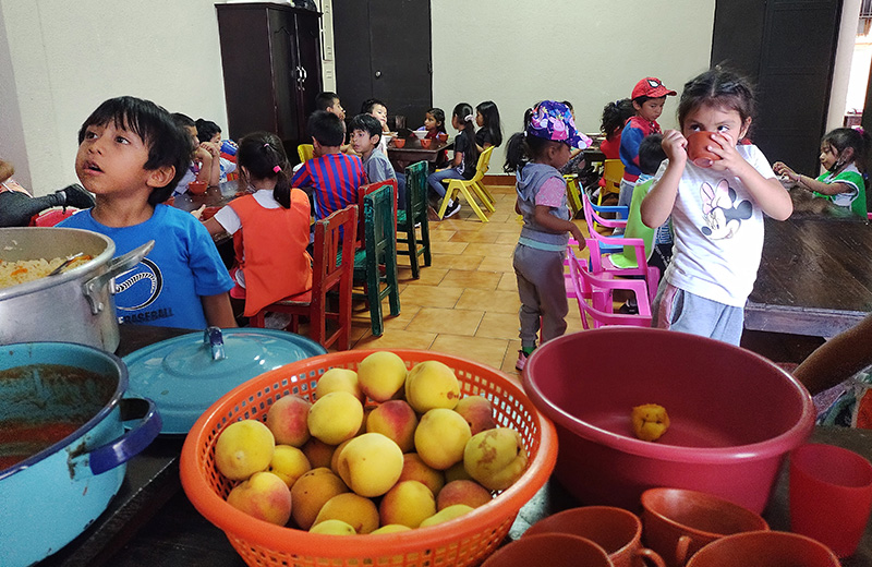 A diverse group of children at a table.